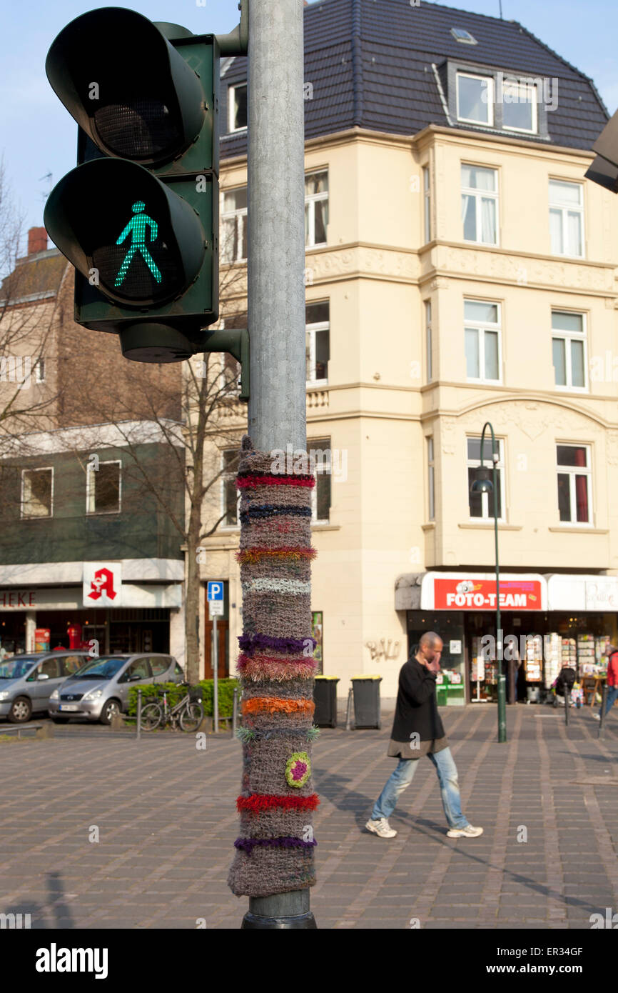 Europe, Germany, North Rhine-Westphalia, Cologne, Guerilla Knitting on a traffic light post at the St. Agnes church, also called Stock Photo