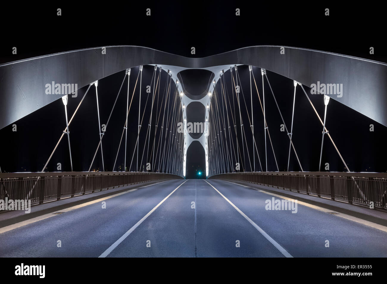 Road on modern frame bridge illuminated at night Stock Photo