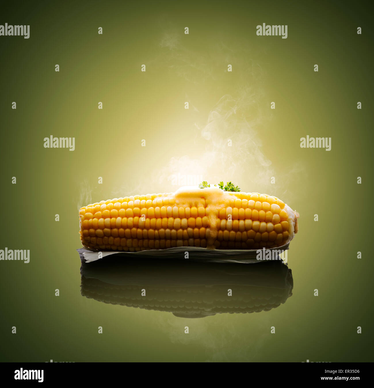 Cooked Ear of Corn with melting hot butter and steam Stock Photo