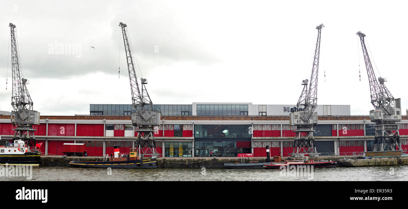 Four preserved electrically powered cargo cranes outside the M Shed