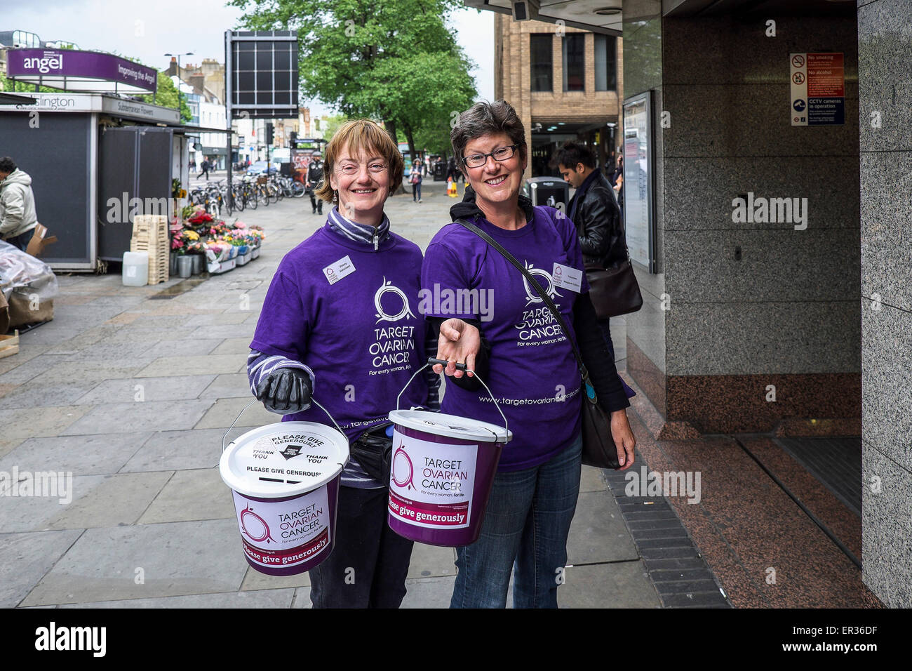 Two cheerful charity workers collecting donations for Target Ovarian Cancer. Stock Photo