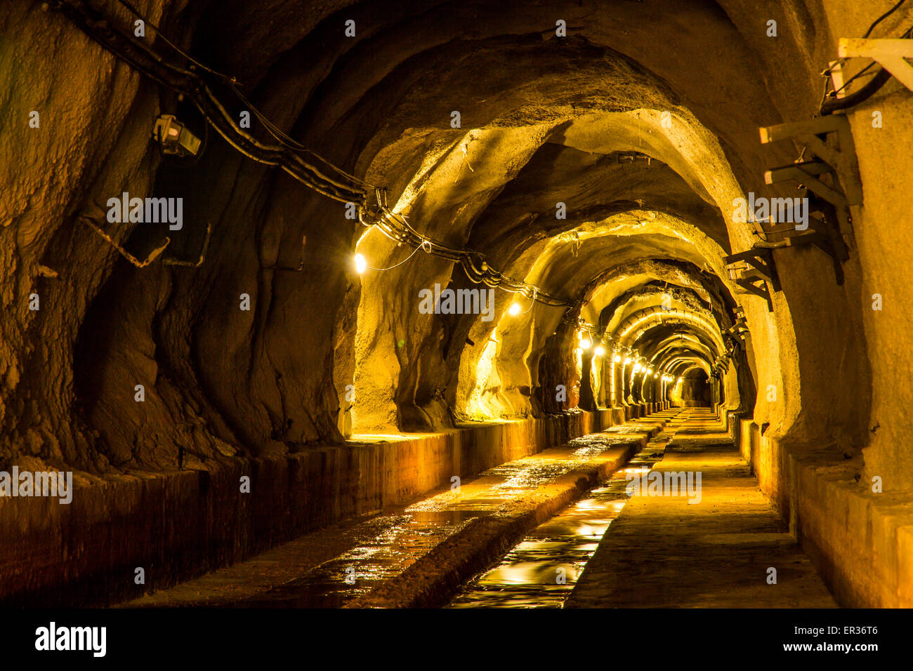 cave tunnel mine long walk way with light Stock Photo