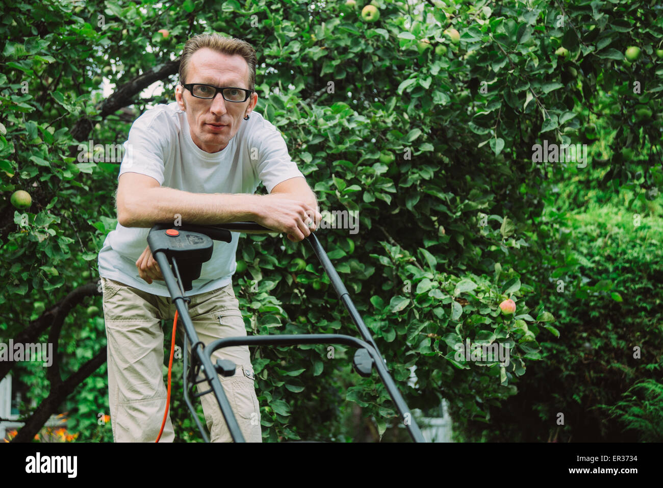 man with lawn mower Stock Photo