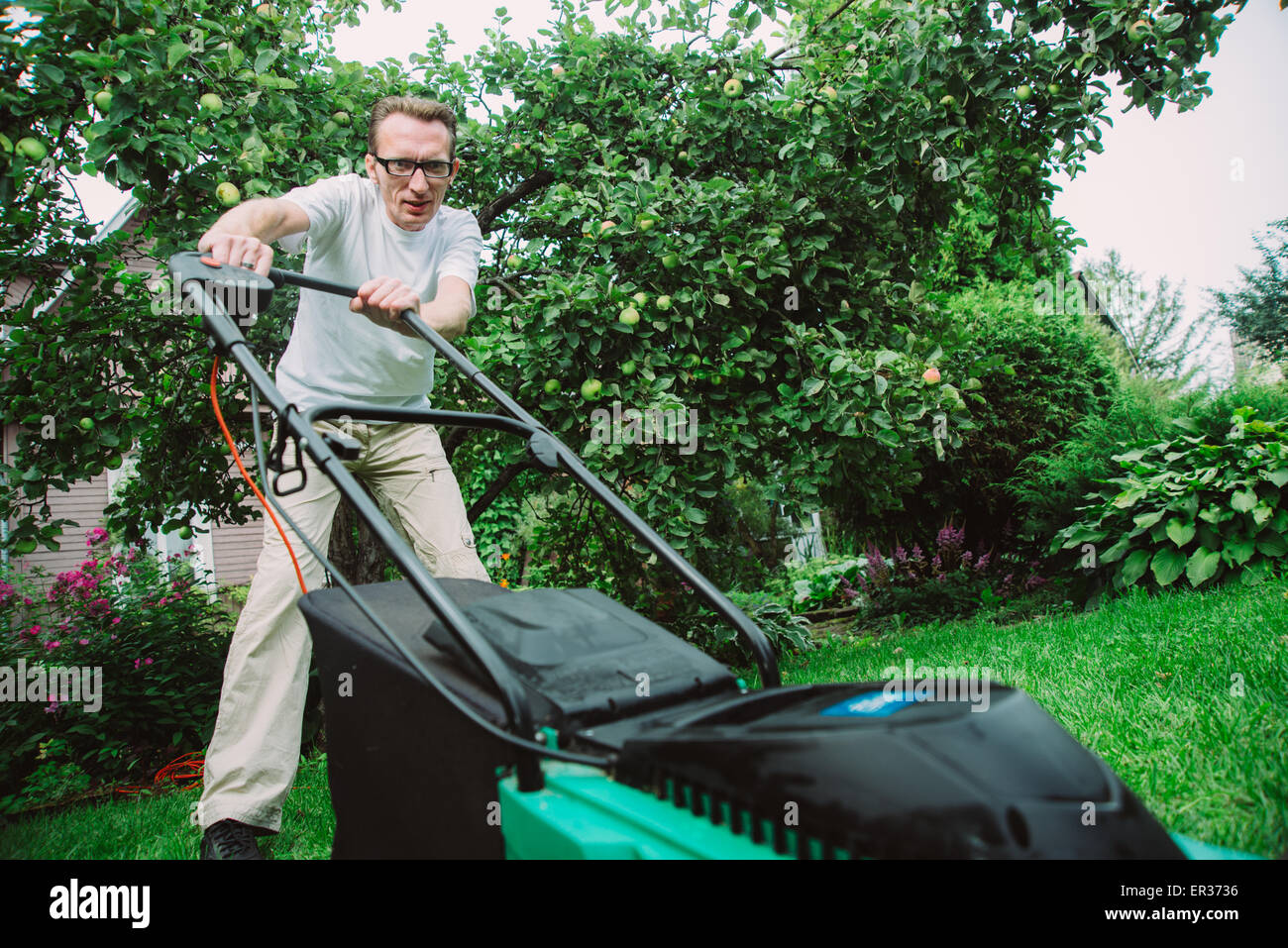 man with lawn mower Stock Photo