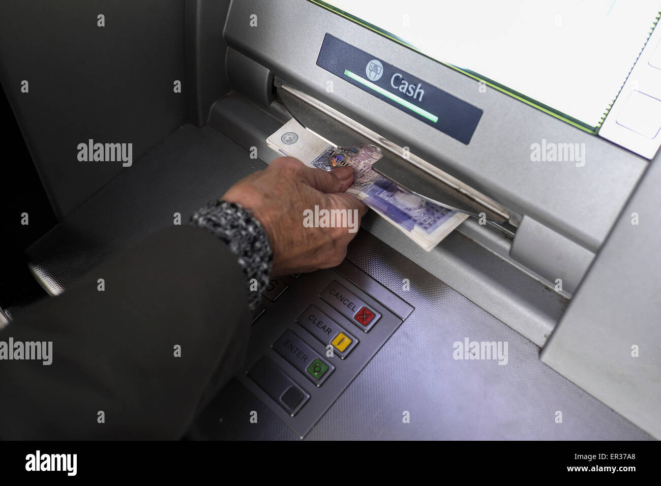 A customer withdrawing money from an ATM. Stock Photo
