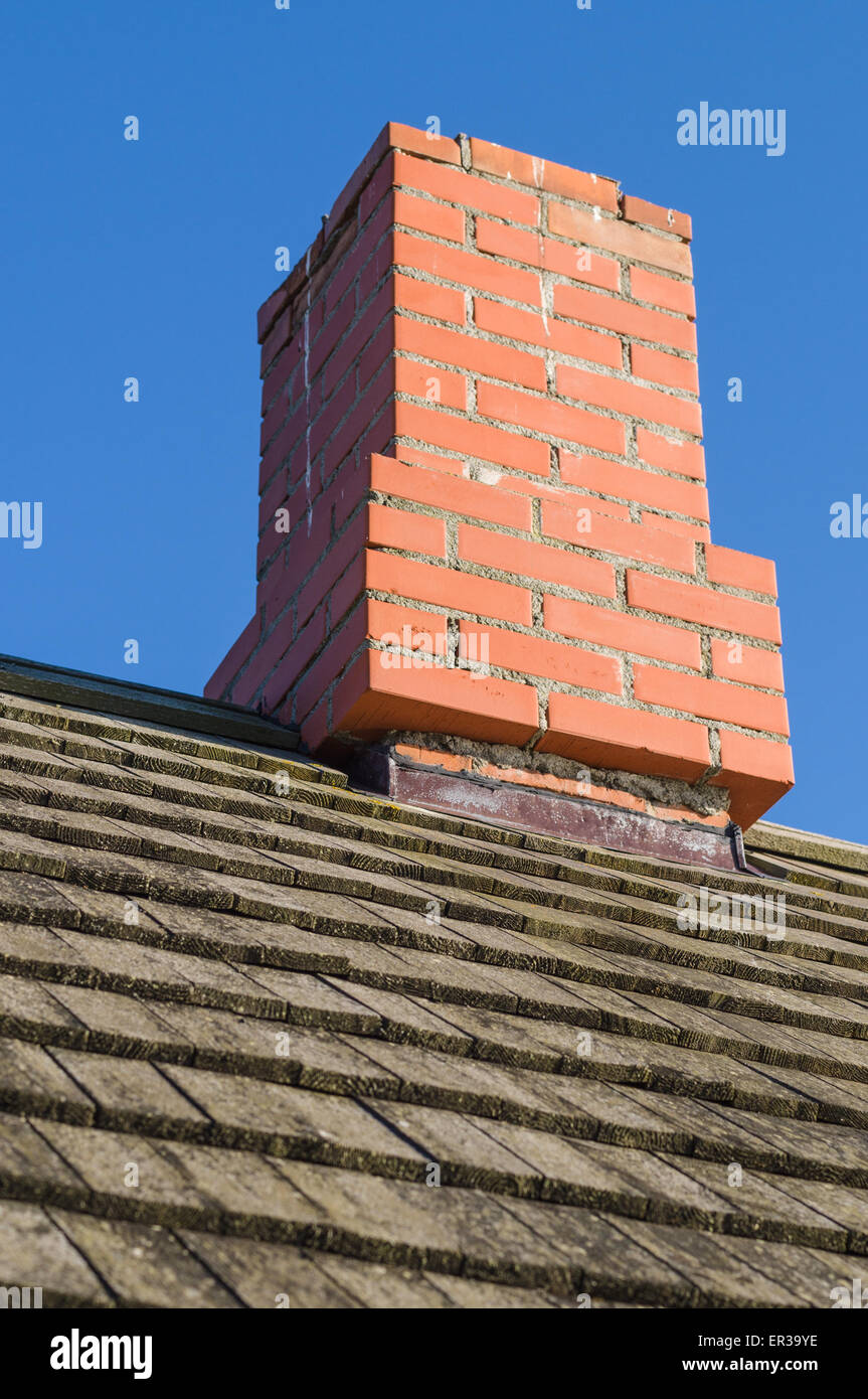 Redbrick chimney and vintage wooden plank roof Stock Photo