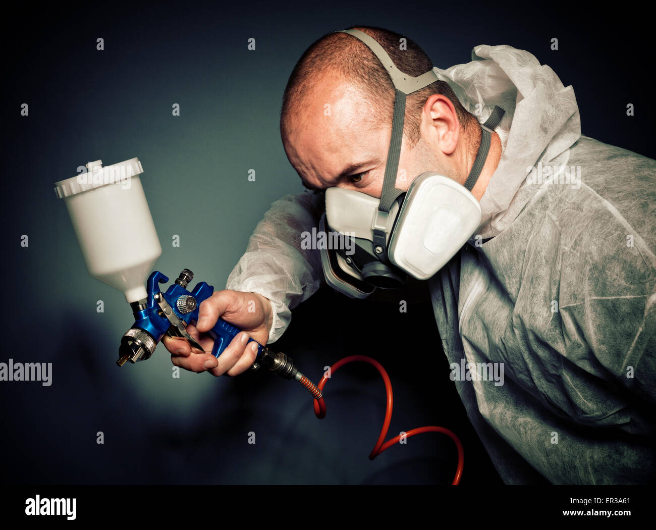 worker with spray-gun and protection clothes Stock Photo