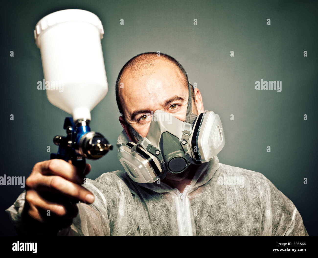 worker with spray-gun and protection clothes Stock Photo