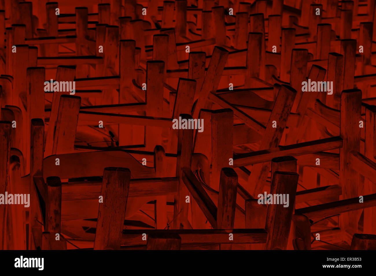 Monochrome image of bunch of chairs turned upside down for background Stock Photo