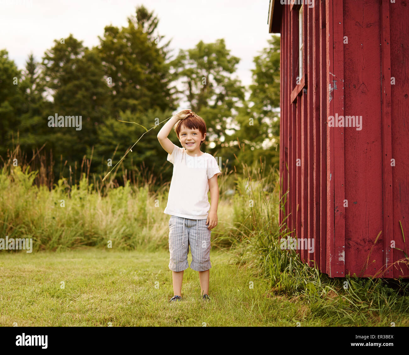 Boy playing outdoors Stock Photo