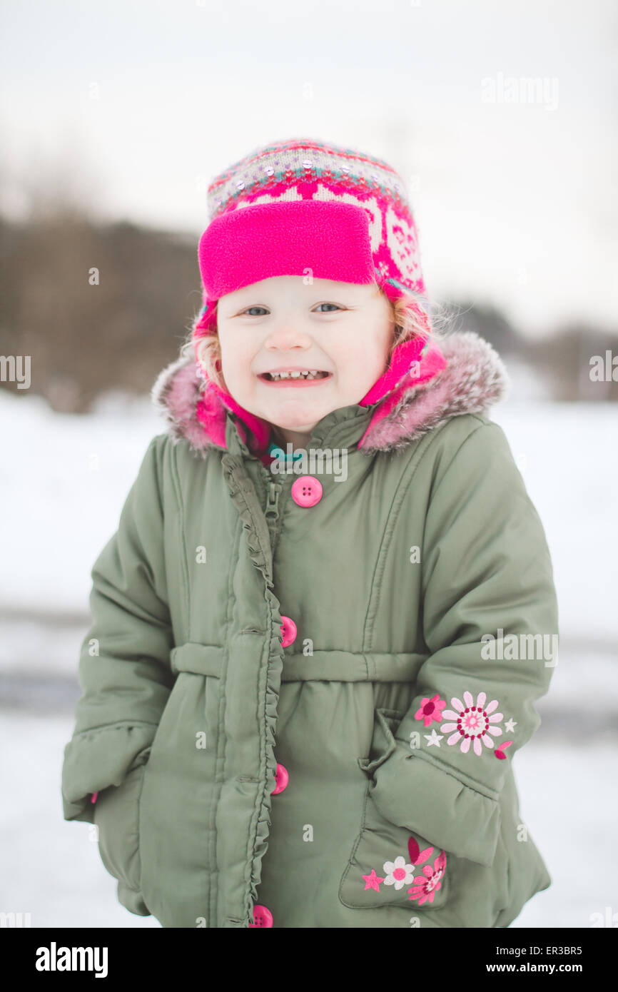 Girl in a winter coat with her hands in her pocket Stock Photo Alamy