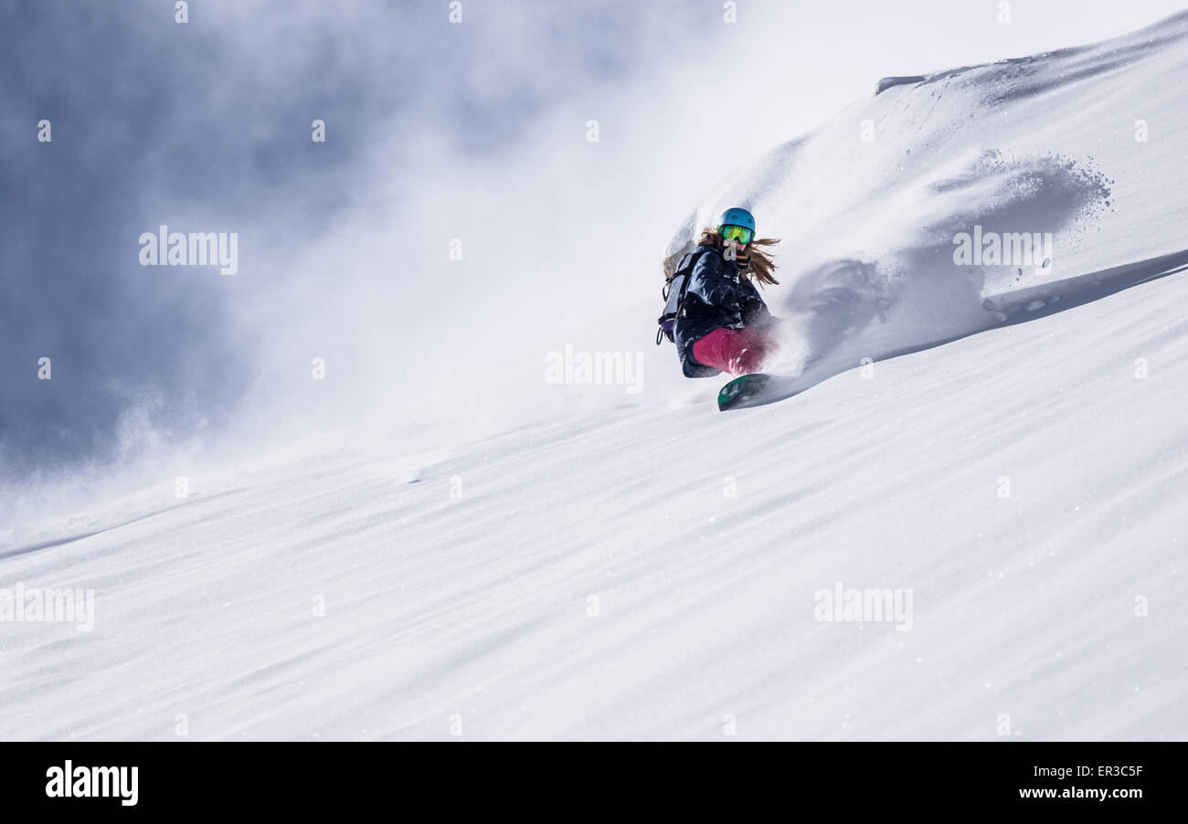 Girl Snowboarding in fresh powder snow, Gastein, Salzburg, Austria Stock Photo