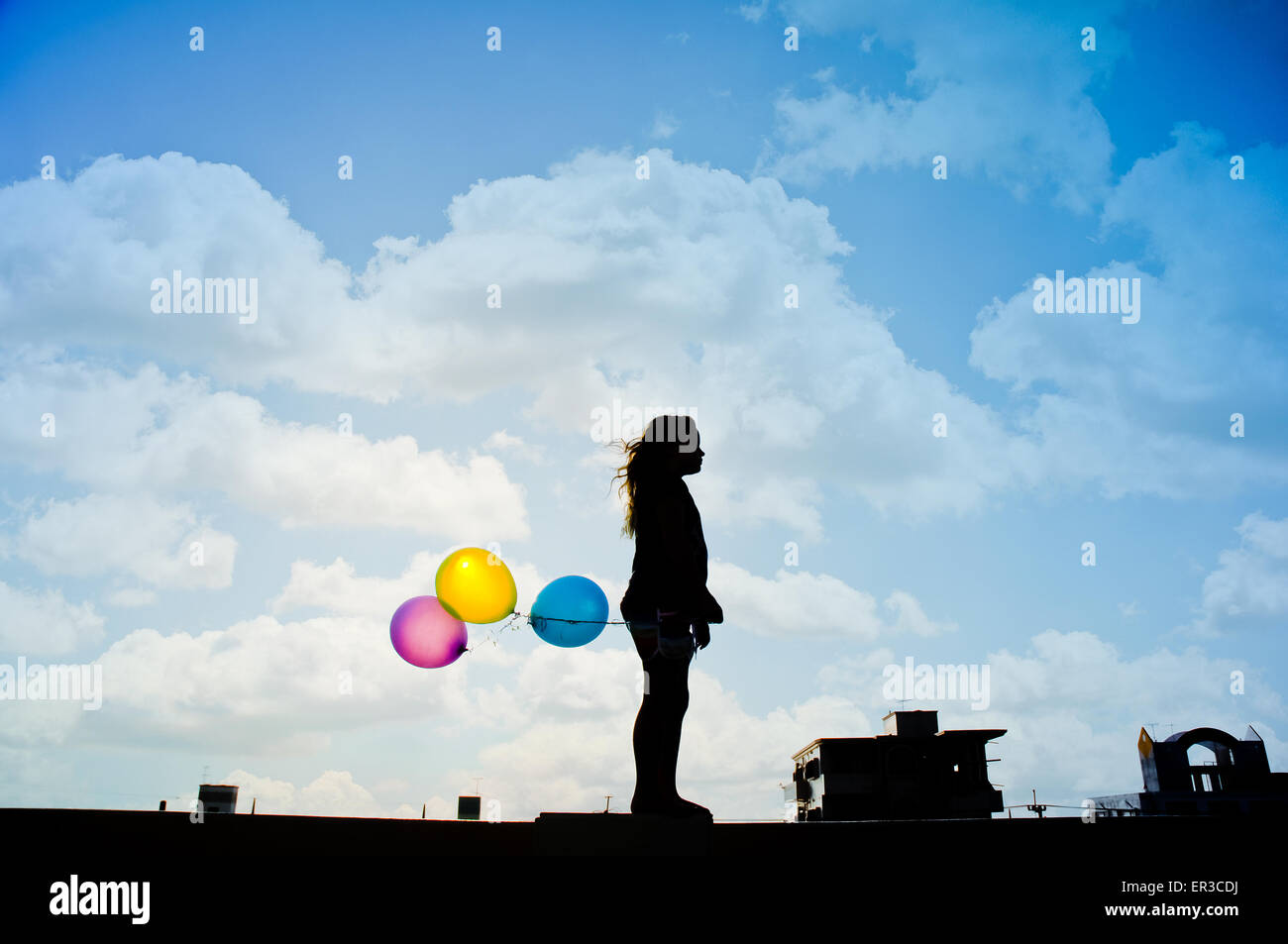 Silhouette of a teenage girl holding balloons Stock Photo Alamy
