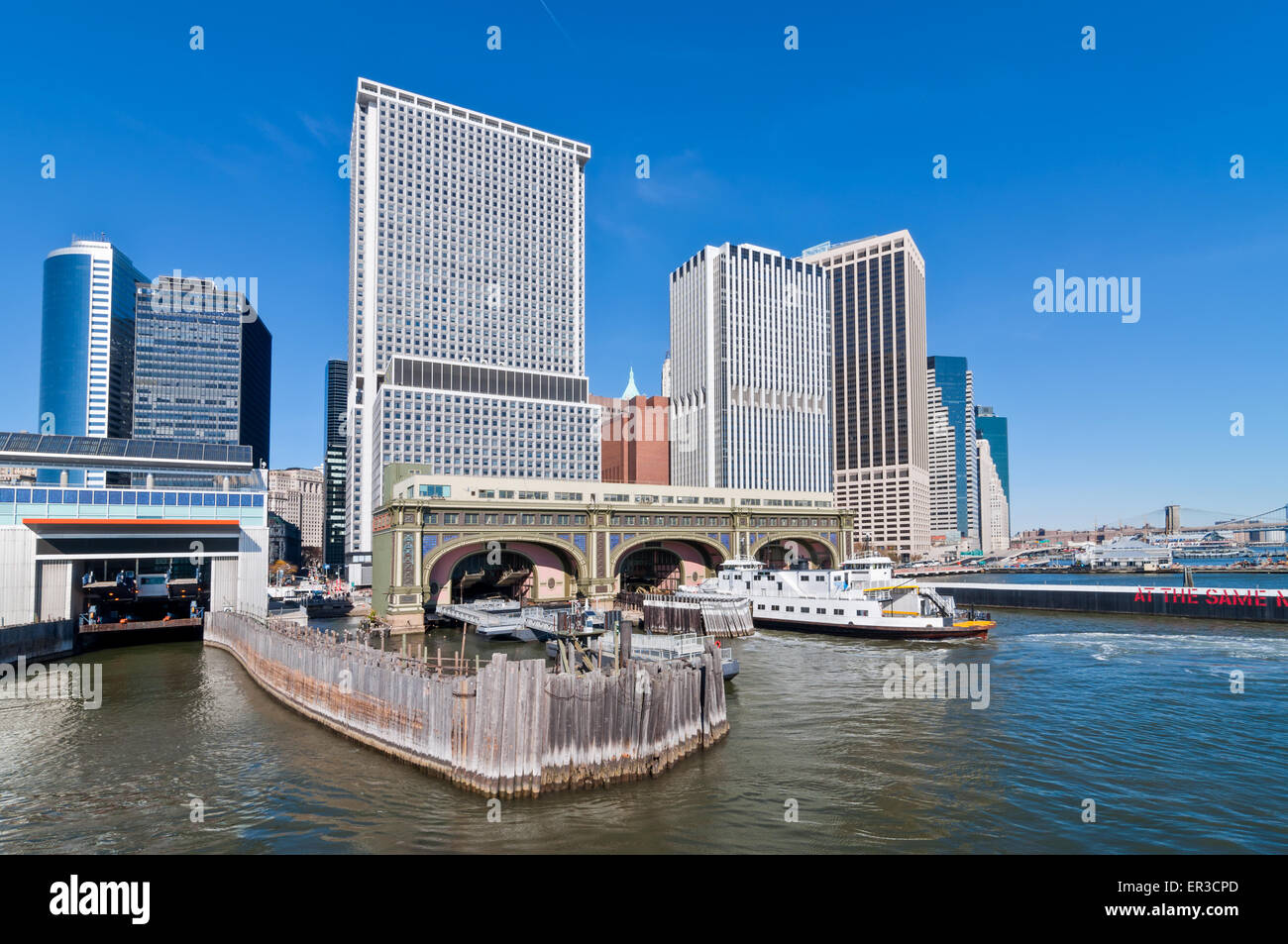 Lower Manhattan from the East River - showing the Battery Maritime Building in the foreground Stock Photo