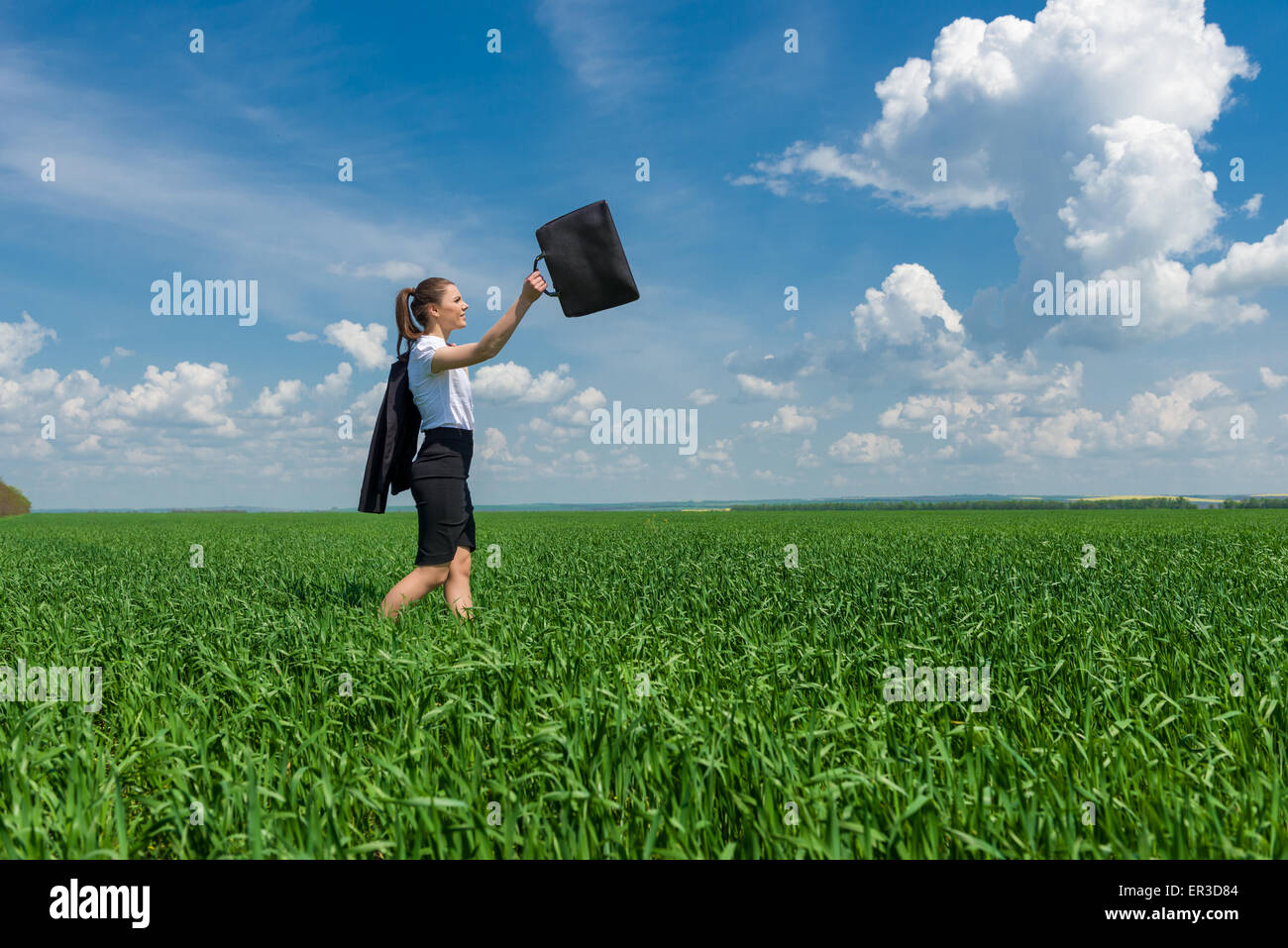 girl with a briefcase walking on the grass Stock Photo Alamy