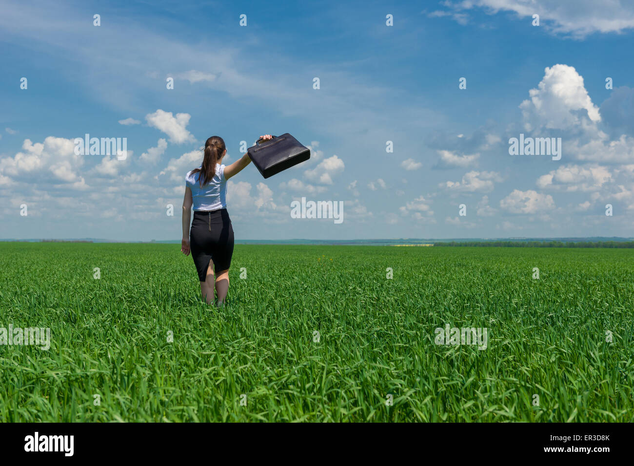 girl with a briefcase walking on the grass Stock Photo - Alamy