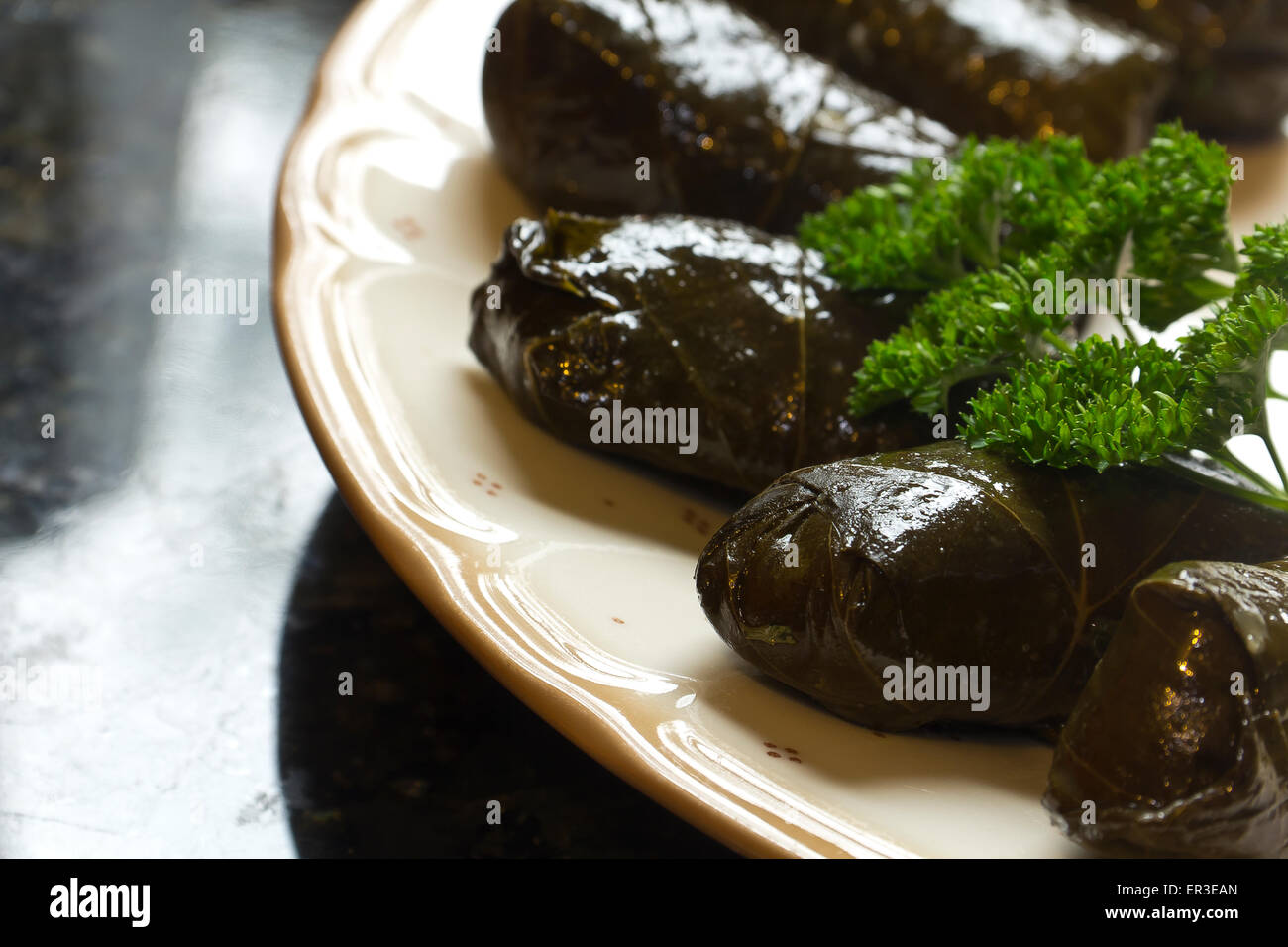 Armenian yaprak dolma, stuffed grape leaves garnished with fresh