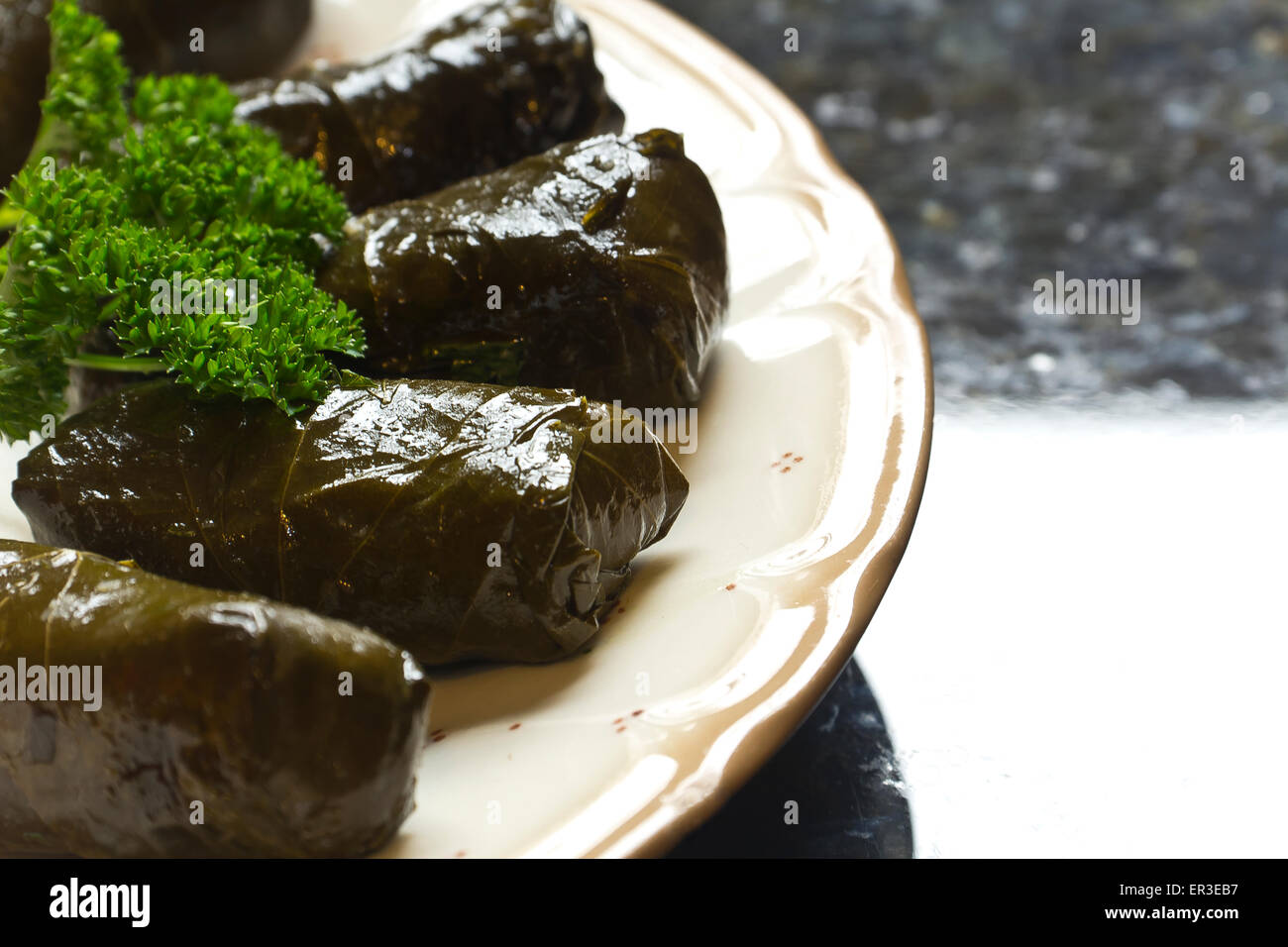 Armenian yaprak dolma, stuffed grape leaves garnished with fresh