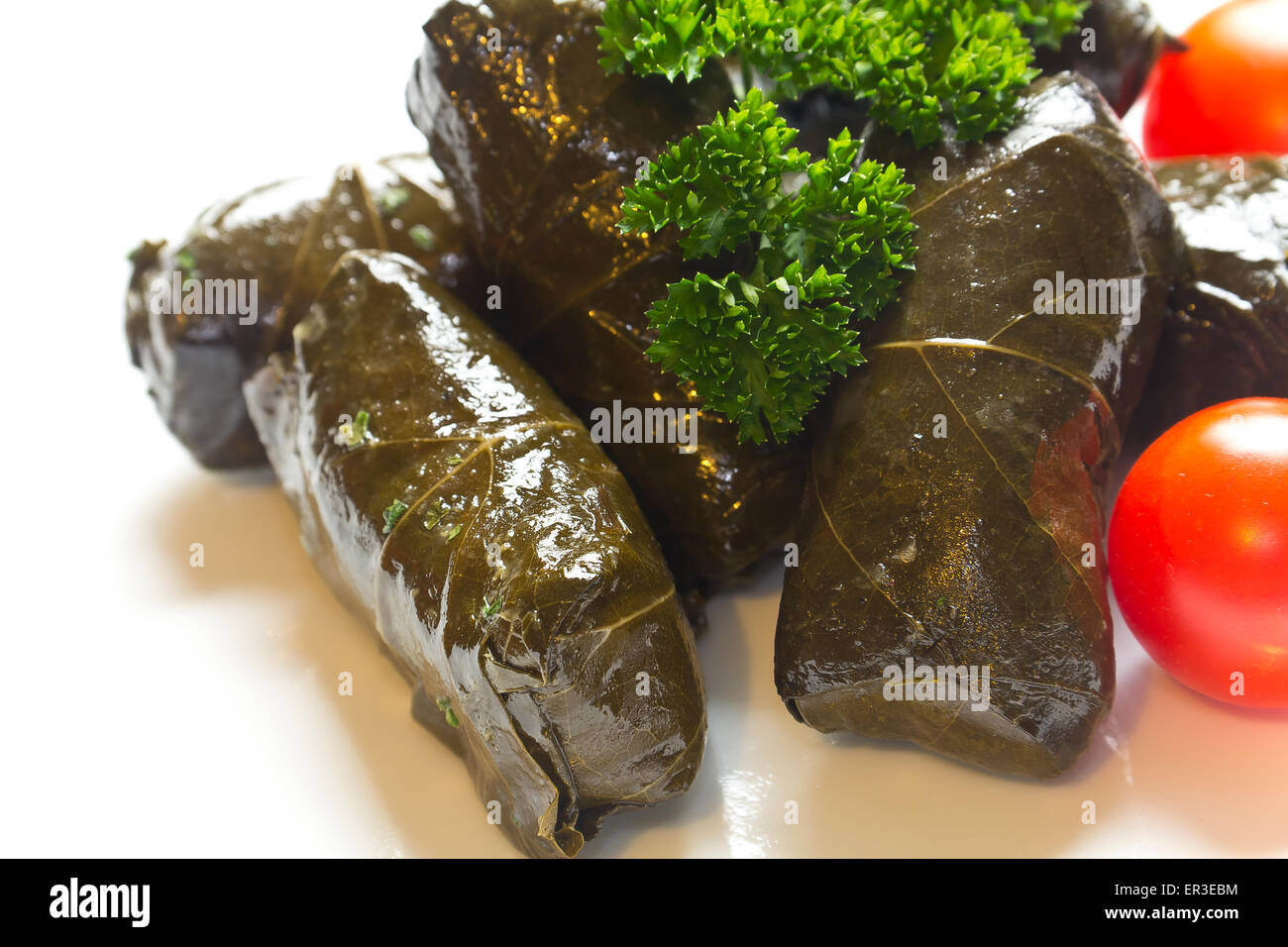 Armenian yaprak dolma, stuffed grape leaves garnished with fresh