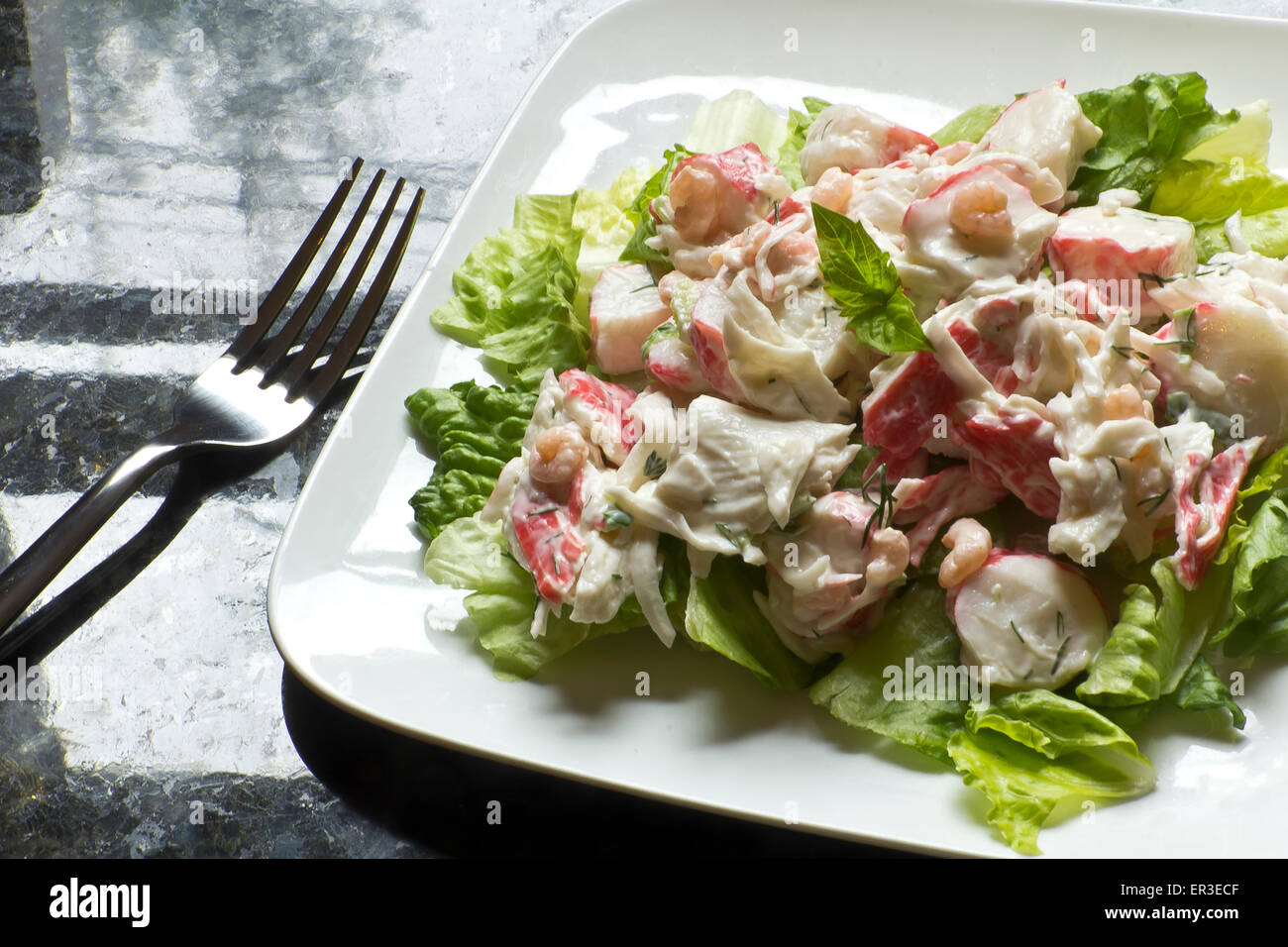 Mayonnaise seafood salad with shrimp and crab meat and fresh dill