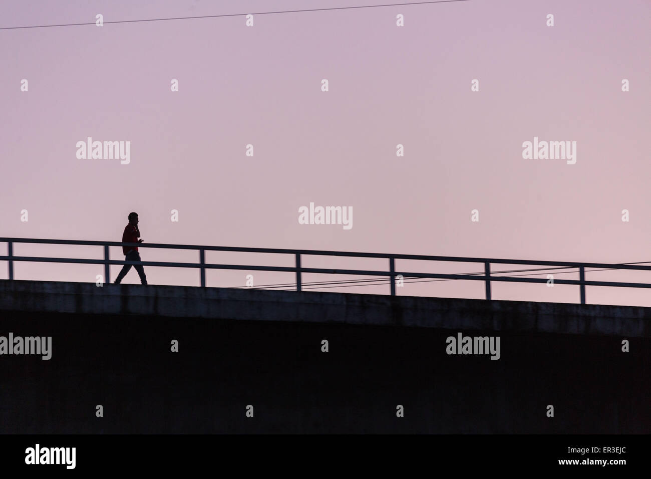 Man walking on a bridge Stock Photo - Alamy