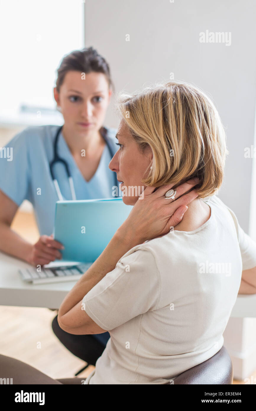 Woman consulting for neck pain. Stock Photo