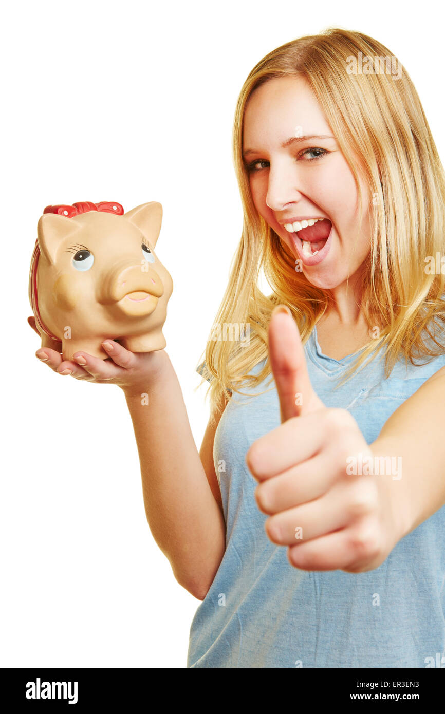 Cheering young blonde woman with piggy bank holding her thumbs up Stock ...