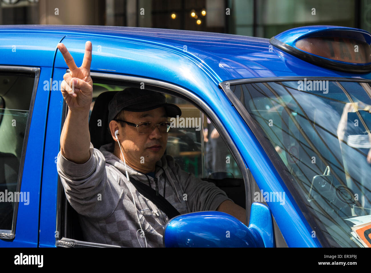 Victoria, London, UK. 26th May, 2015.  London's cabbies protest near Transport For London's HQ in Victoria against what they say is unfair competition from less regulated minicab operators who are supposed to take only pre-booked fares but are picking up passengers off the street, and the peer to peer Uber taxi-booking app which is making operating a licenced London taxi unsustainable. Credit:  Paul Davey/Alamy Live News Stock Photo