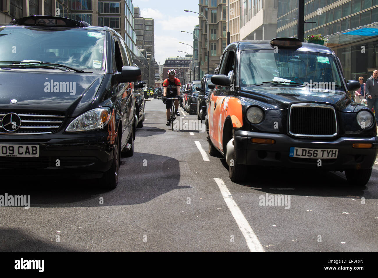 Victoria, London, UK. 26th May, 2015.  London's cabbies protest near Transport For London's HQ in Victoria against what they say is unfair competition from less regulated minicab operators who are supposed to take only pre-booked fares but are picking up passengers off the street, and the peer to peer Uber taxi-booking app which is making operating a licenced London taxi unsustainable. Credit:  Paul Davey/Alamy Live News Stock Photo