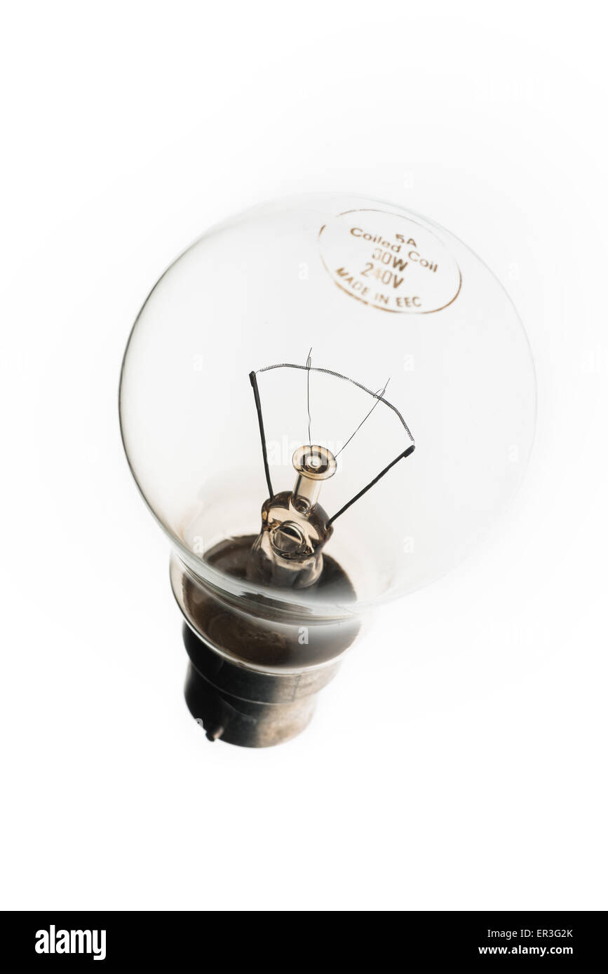 Tungsten wire filament in clear light bulb chamber indicating flow of electricity and current or