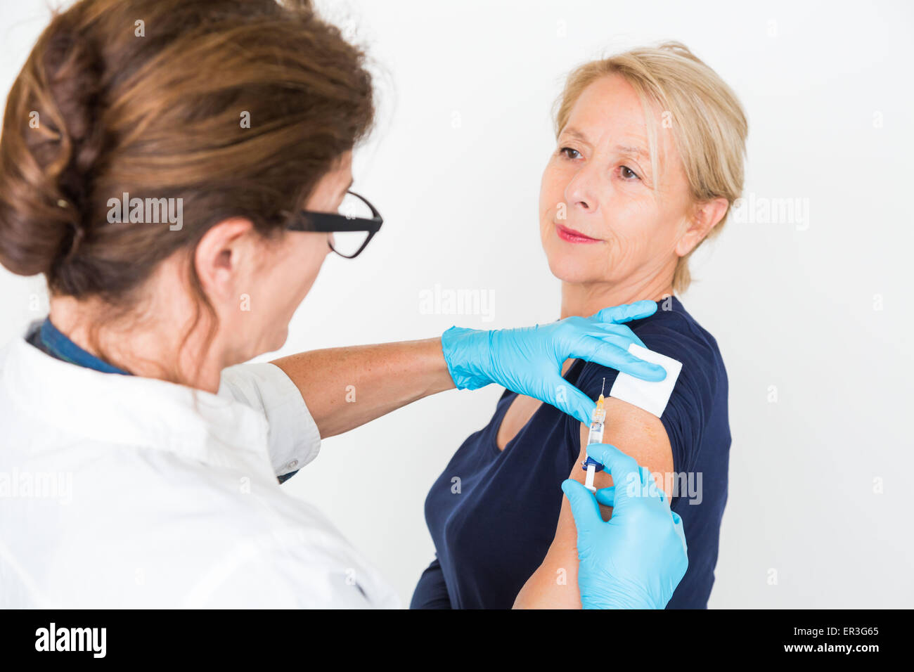 Woman receiving vaccination. Stock Photo