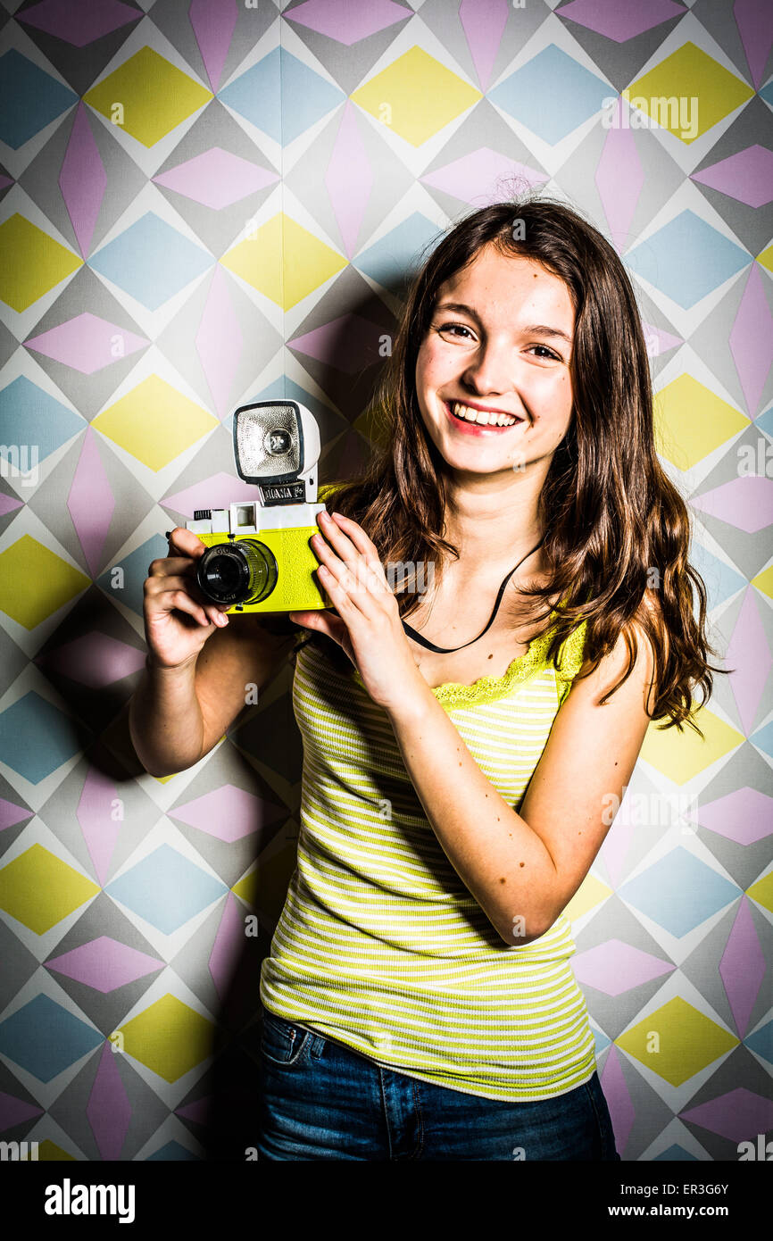 Teenage girl using a camera. Stock Photo