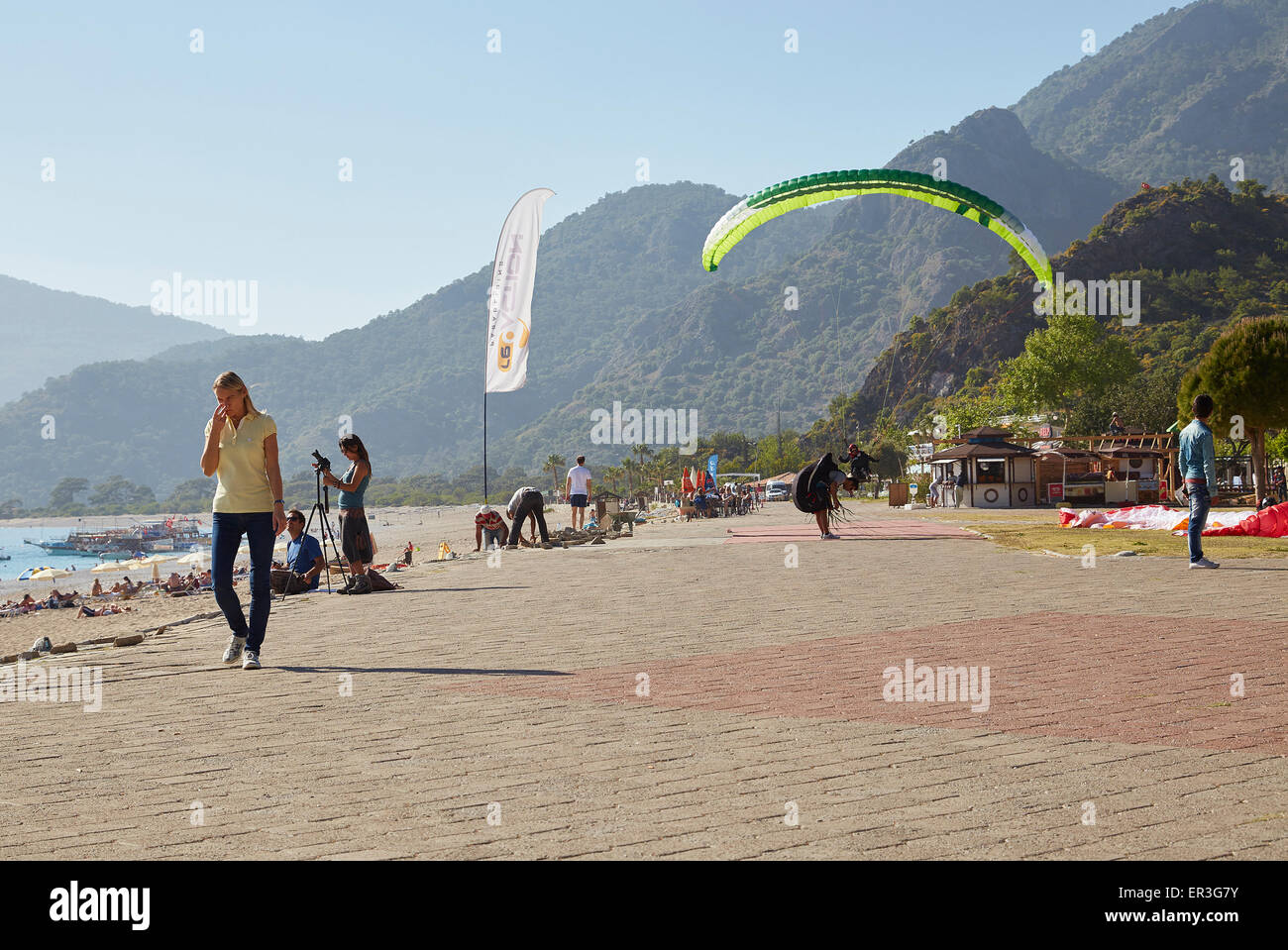 Paragliding in Oludeniz, Near Fethiye, Turkey. Coming in to land on the beachfront. Stock Photo