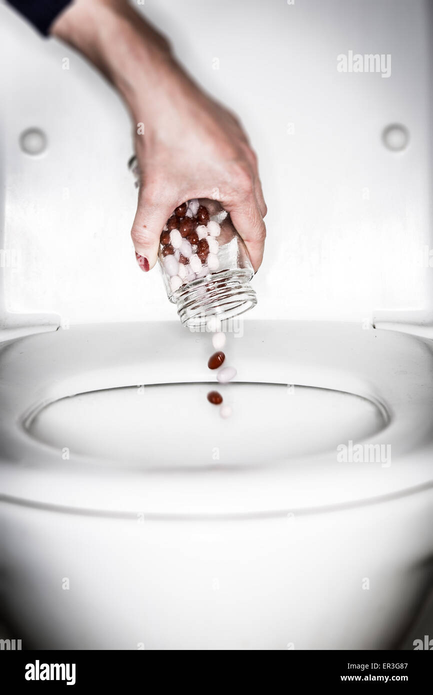 Hand Throwing Pills Away. Health Concept Stock Photo, Picture and