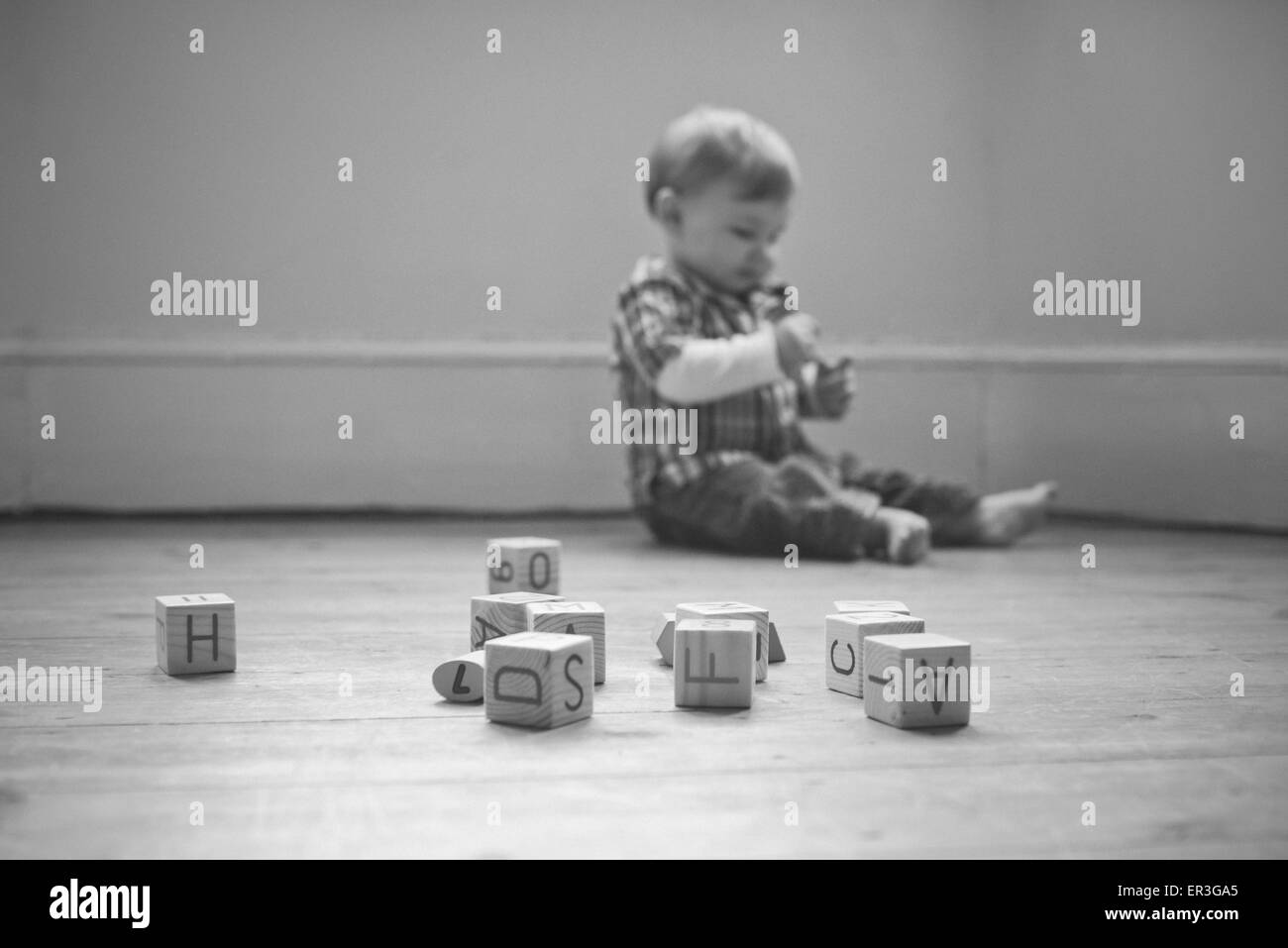 Baby boy playing on floor in nursery Stock Photo