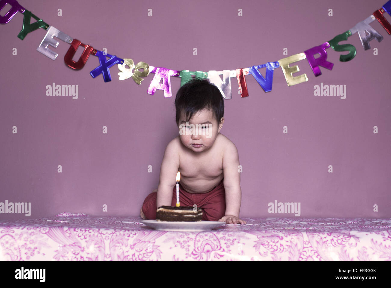 Baby blowing out birthday candle Stock Photo Alamy