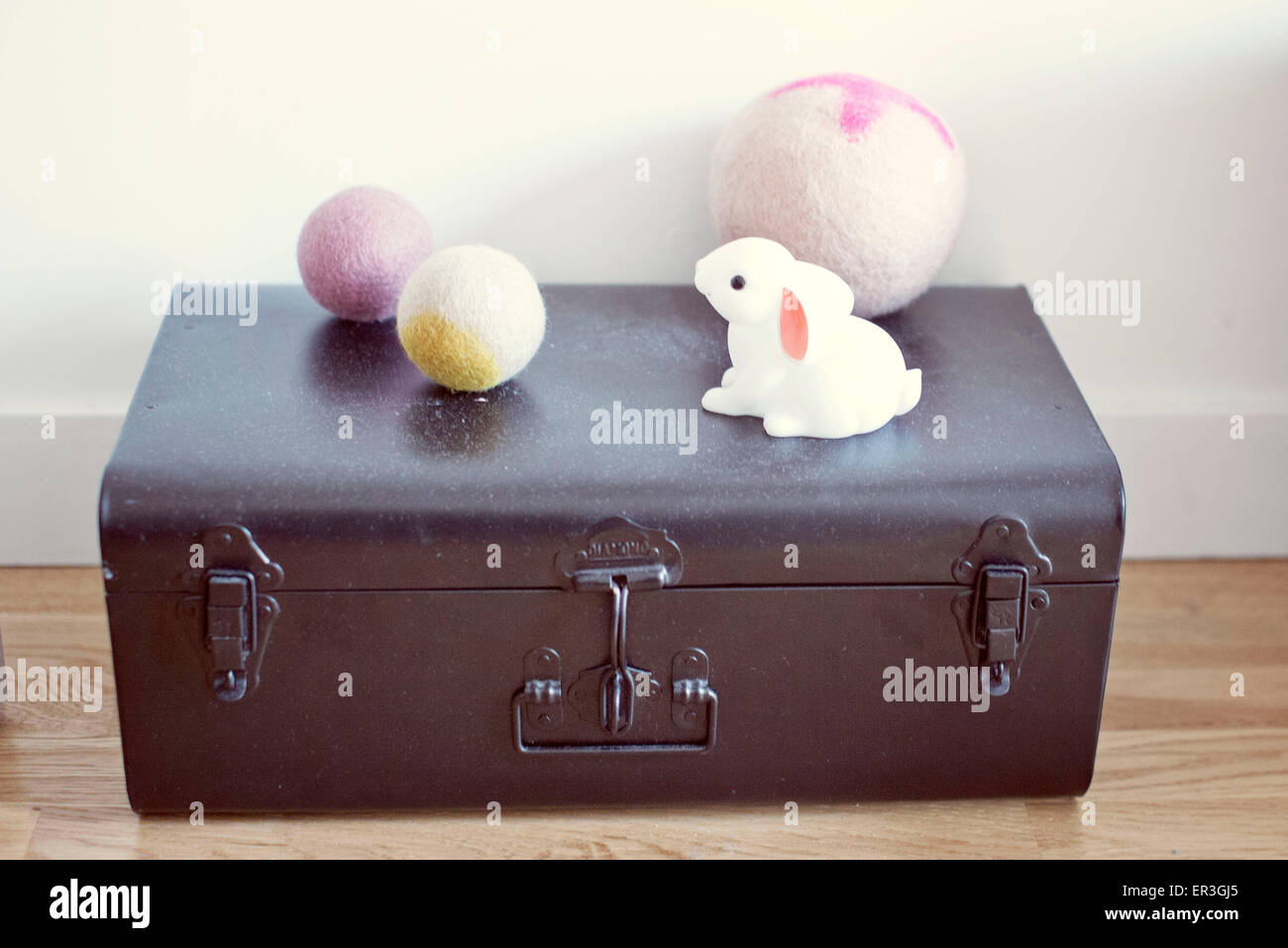 Child's toys on top of metal trunk Stock Photo
