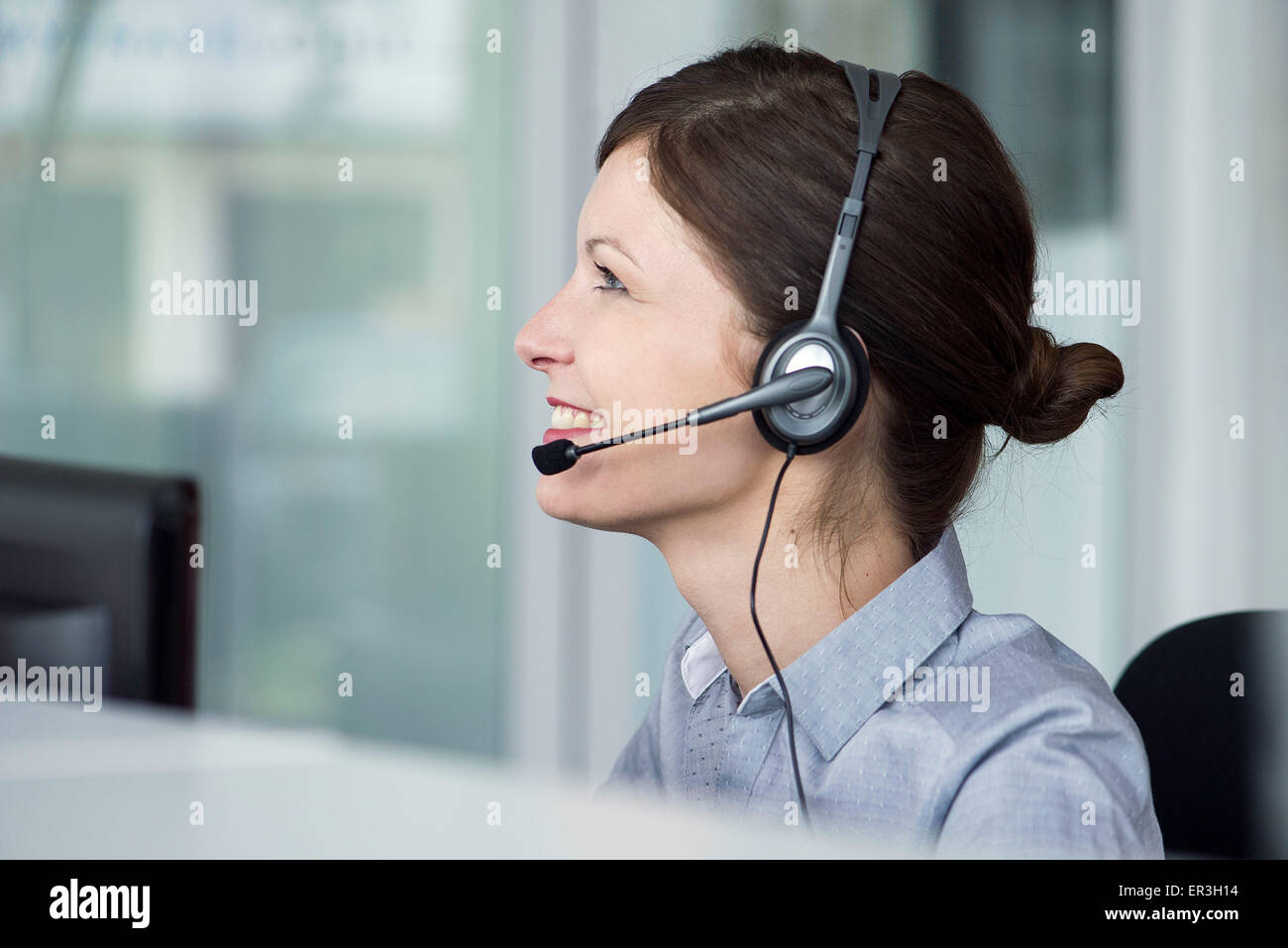 Receptionist wearing headset Stock Photo Alamy