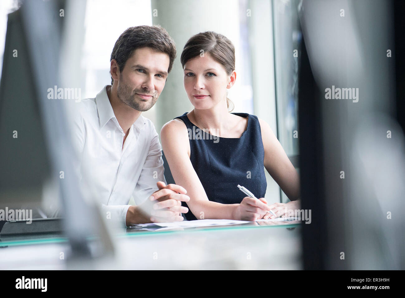 Business associates working closely together Stock Photo - Alamy