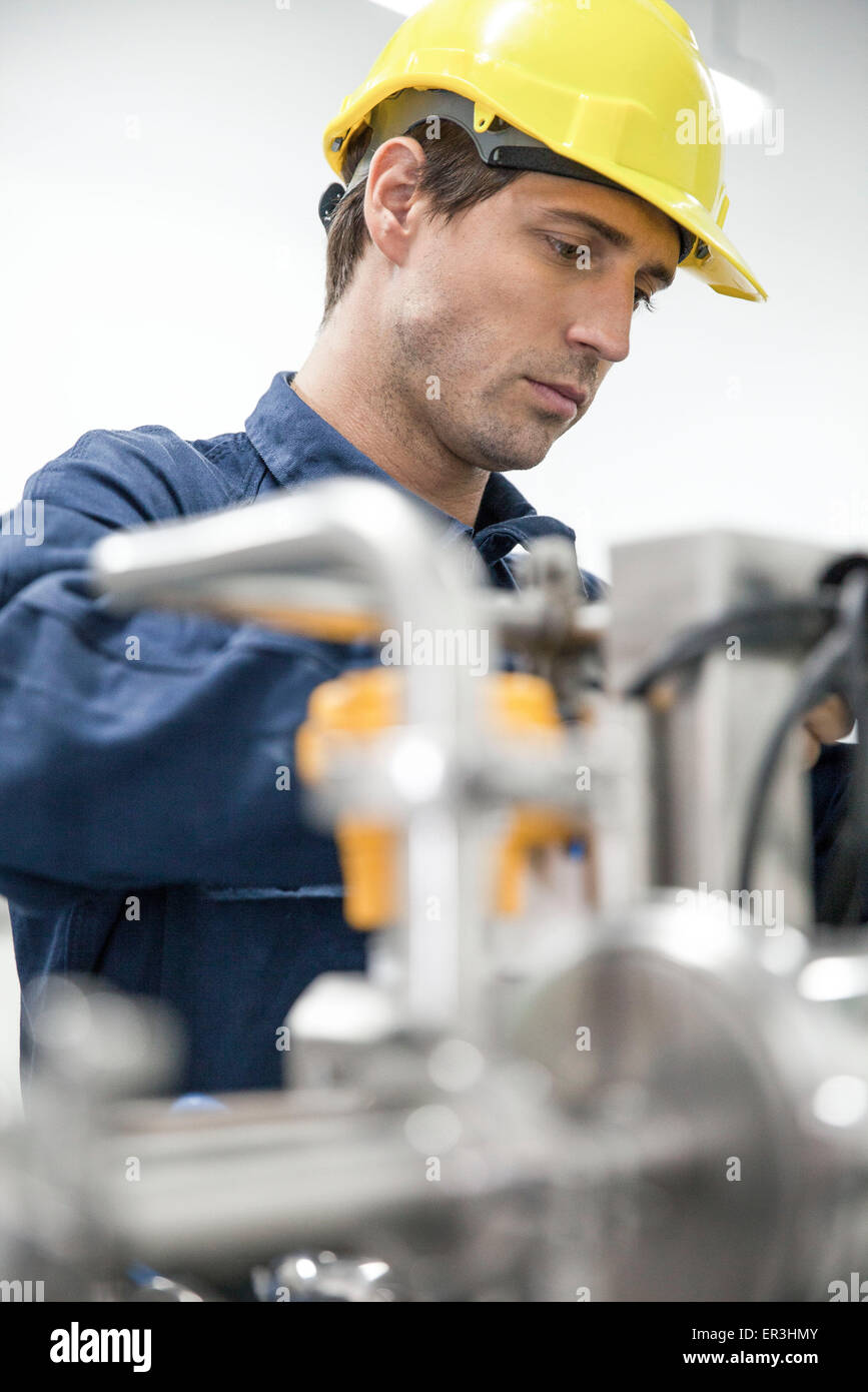Blue-collar worker at work in factory Stock Photo