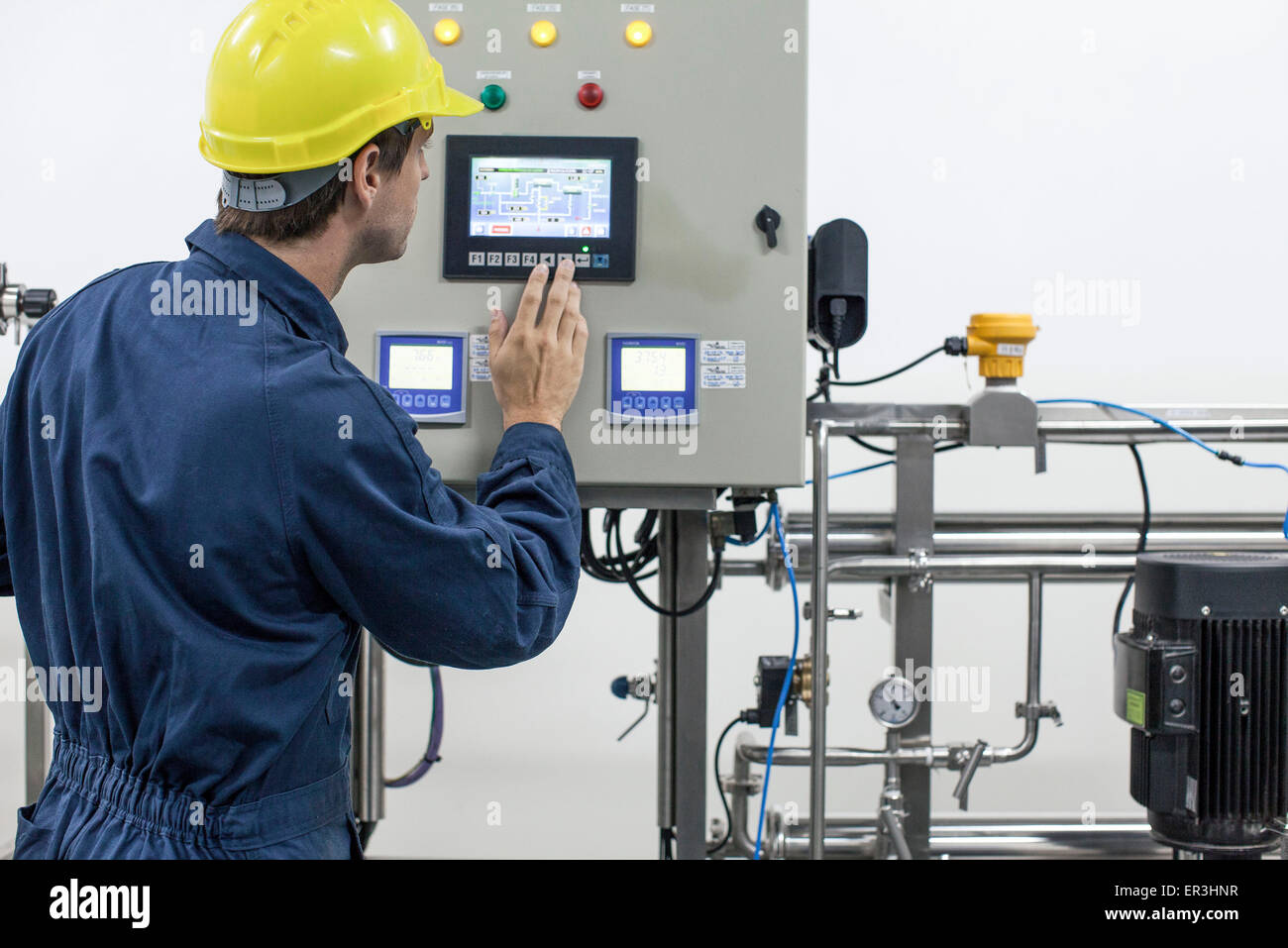 Skilled worker operating industrial equipment Stock Photo