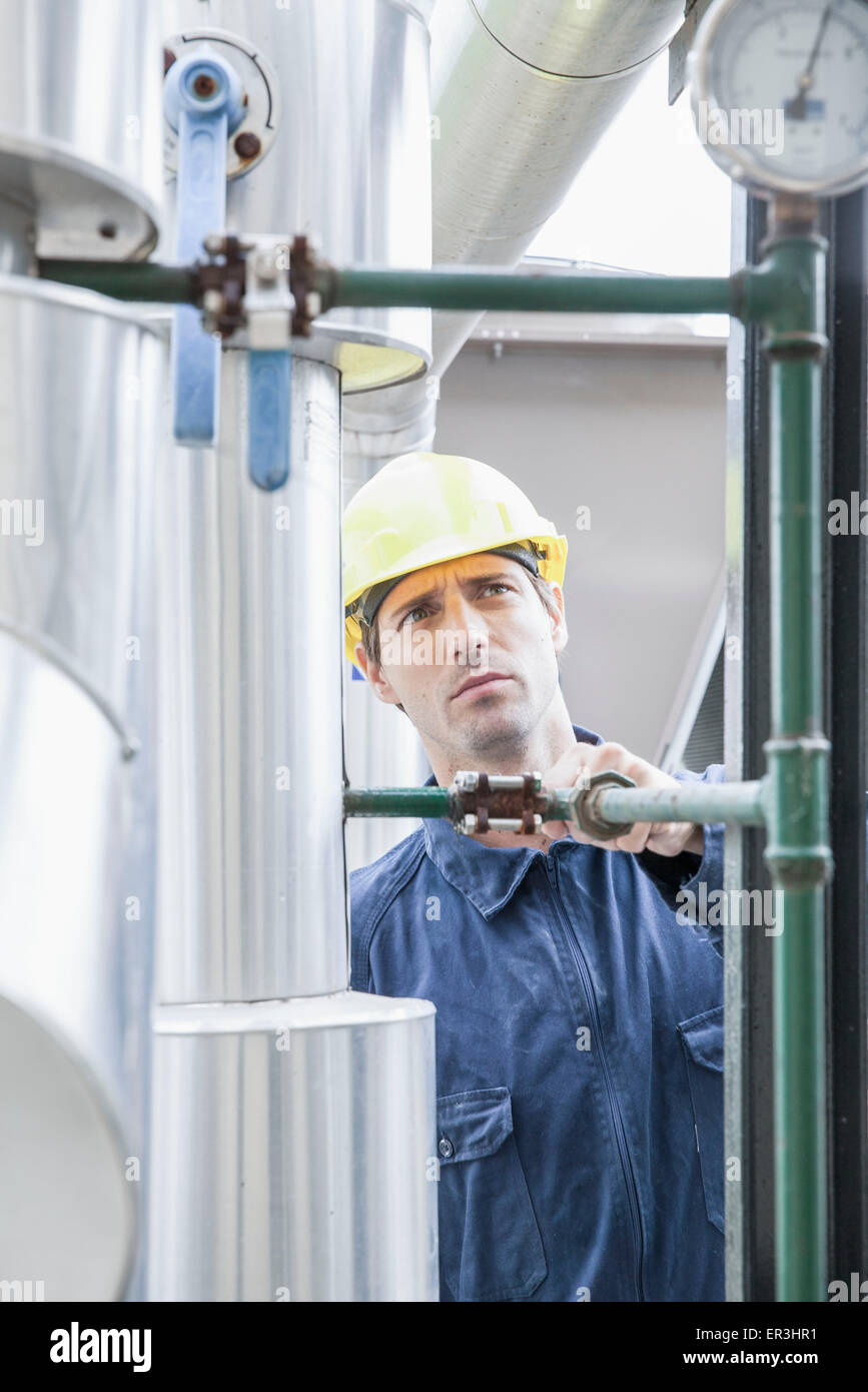 Skilled worker inspecting industial equipment Stock Photo