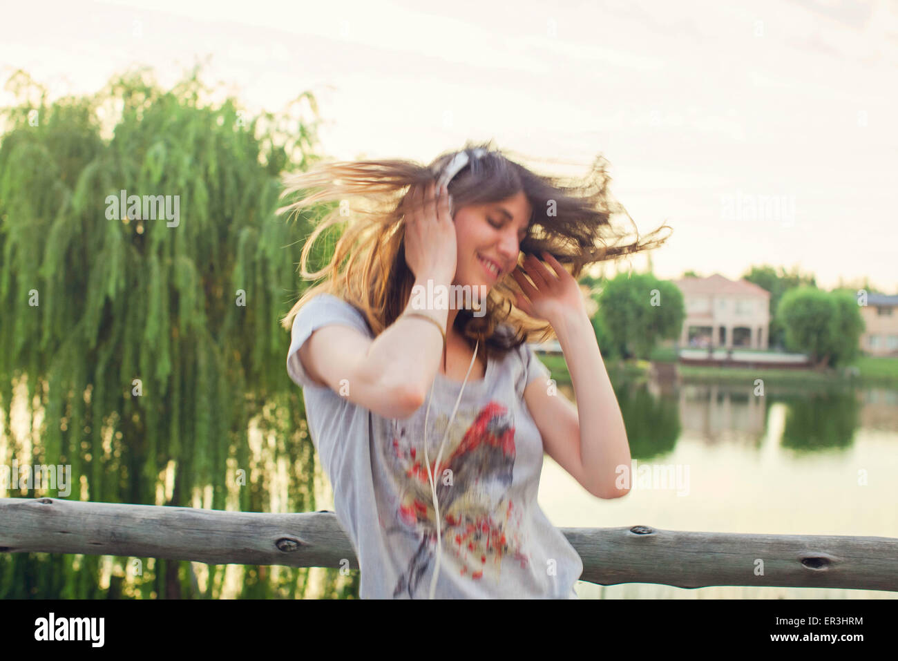 Young woman enthusiatically listening to music Stock Photo