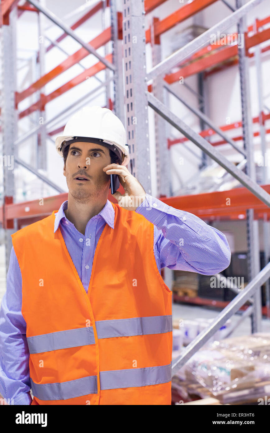 Factory worker using cell phone, portrait Stock Photo - Alamy