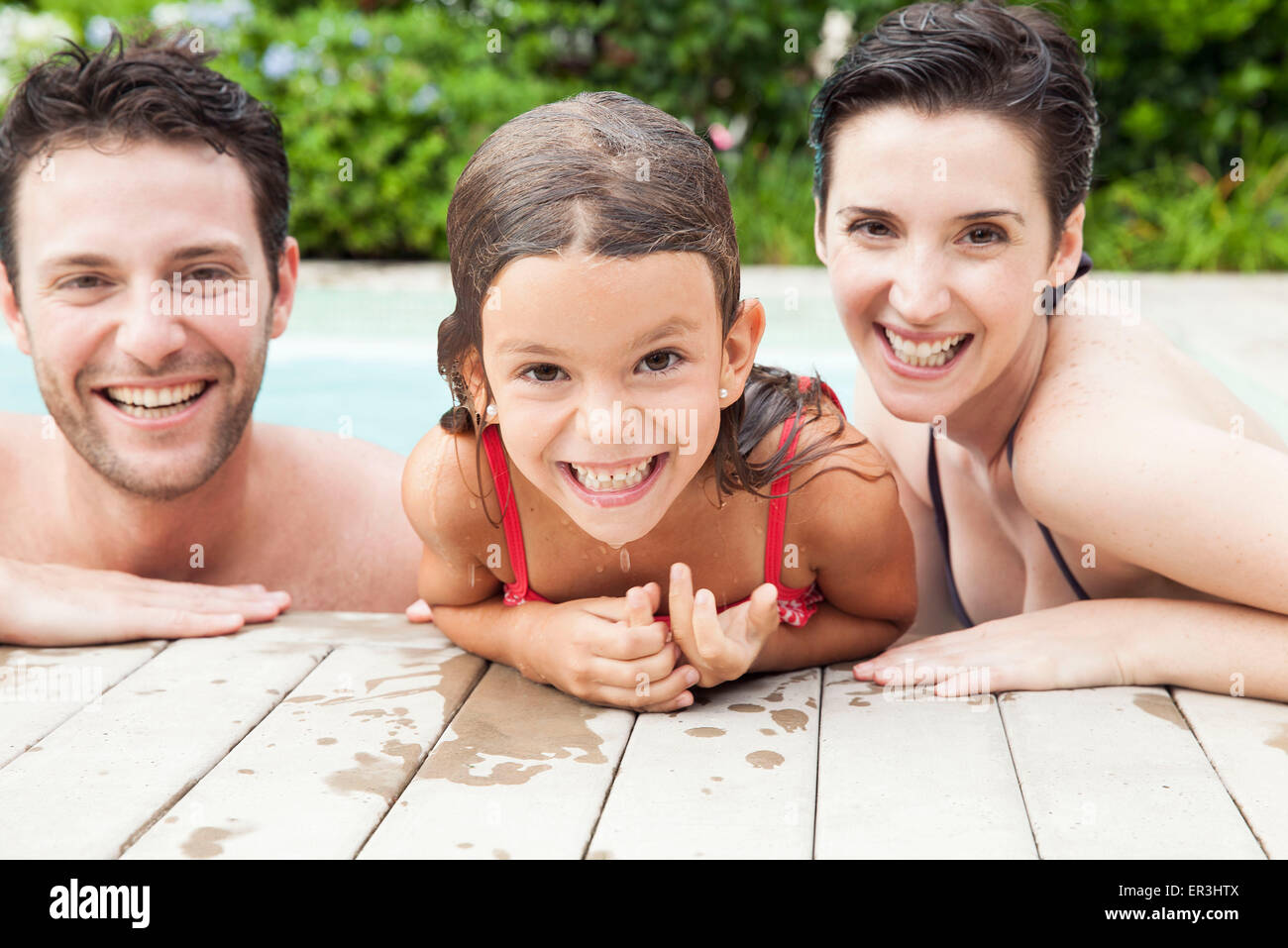 Family relaxing together in pool, portrait Stock Photo