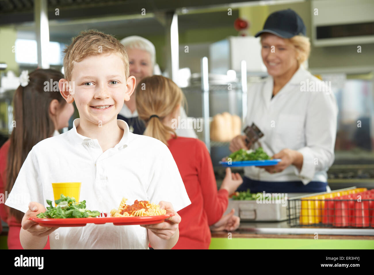 Male Pupil With Healthy Lunch In School Cafeteria Stock Photo