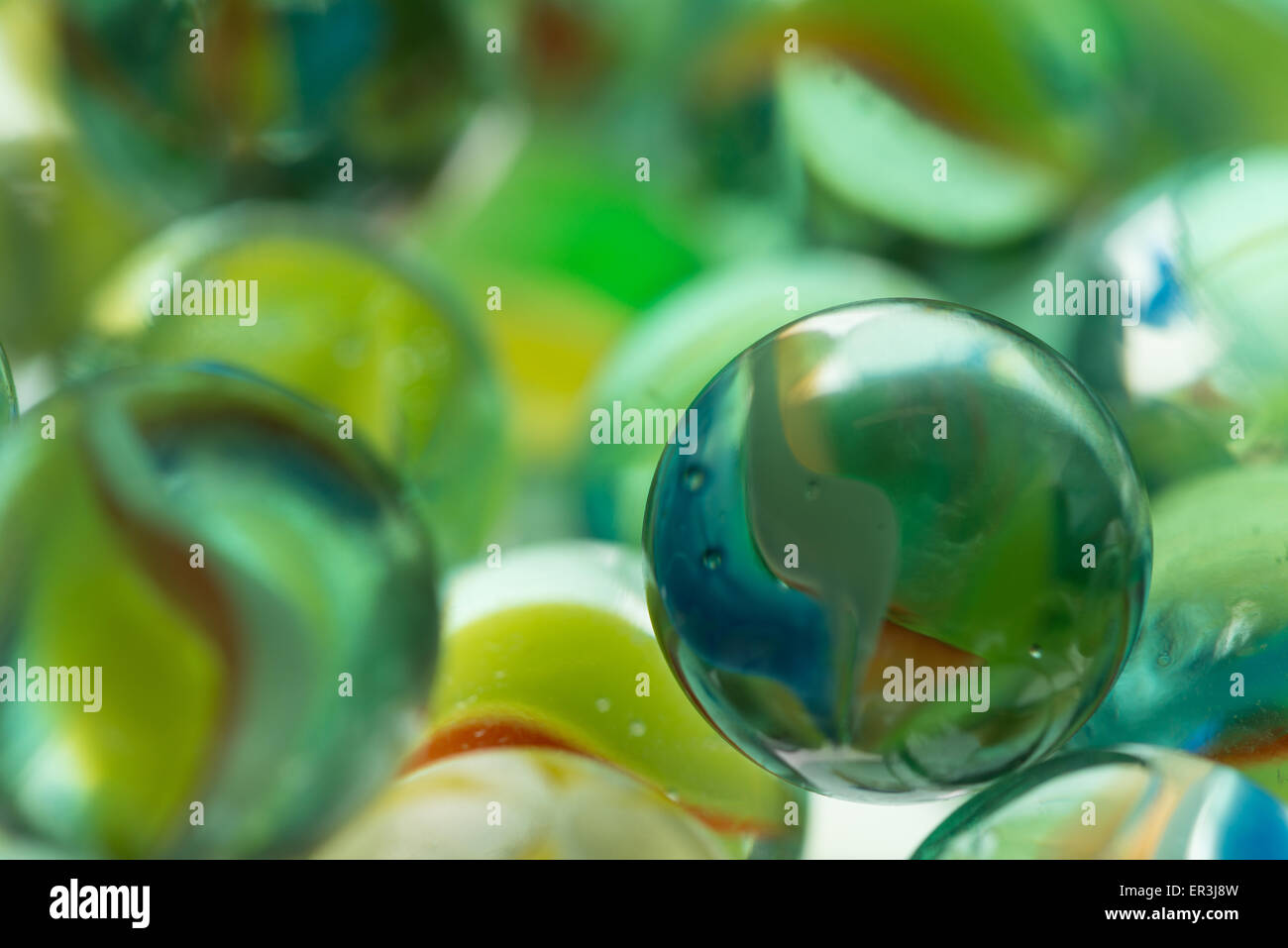 collection of old glass transparent marbles with unique swirls of colored glass trapped inside Stock Photo