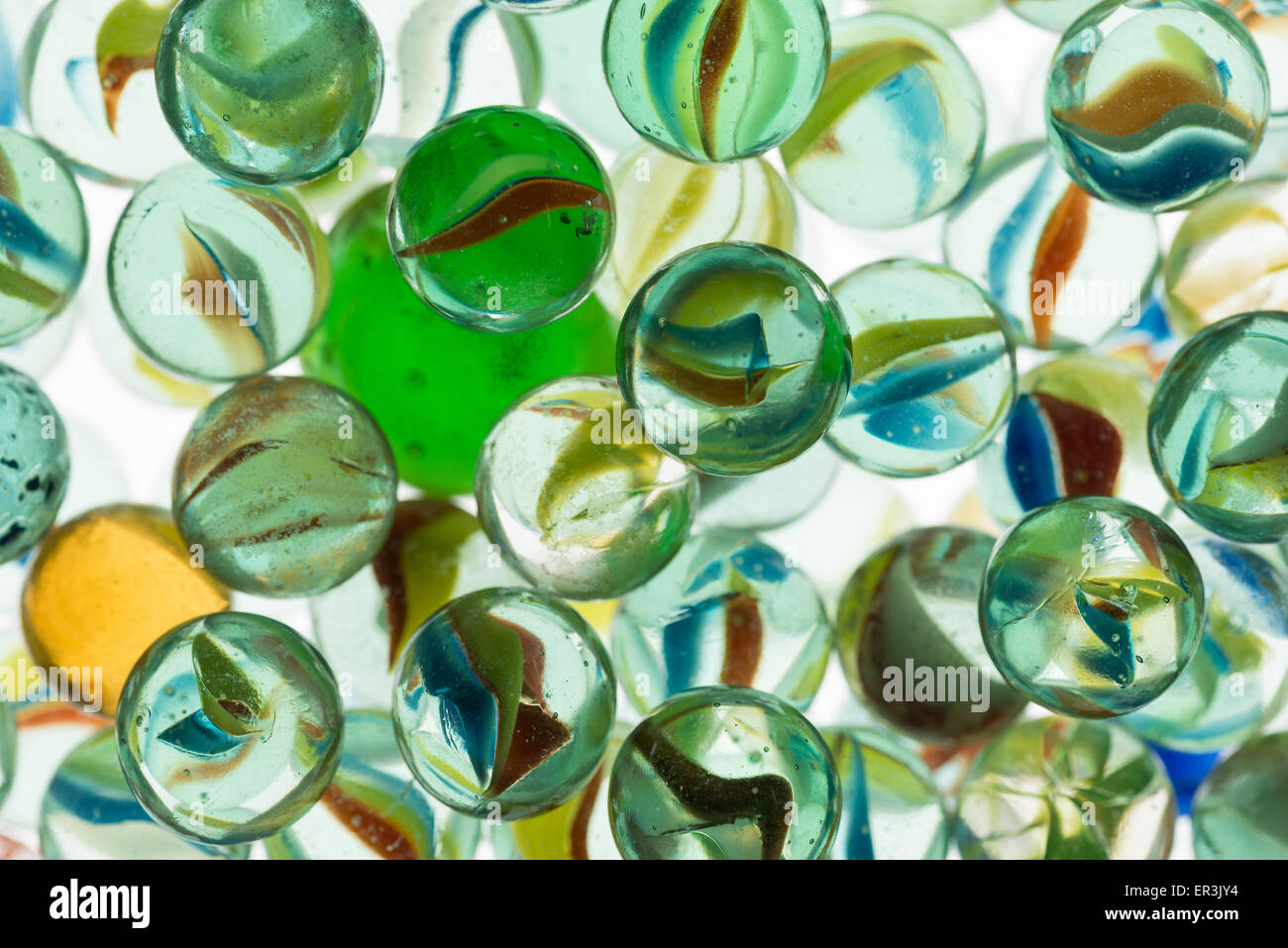 collection of old glass transparent marbles with unique swirls of colored glass trapped inside Stock Photo