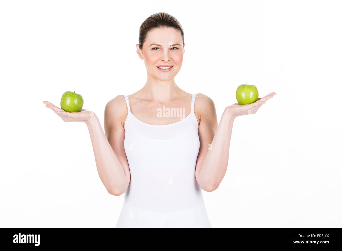 young woman holding two apples and looking at camera Stock Photo
