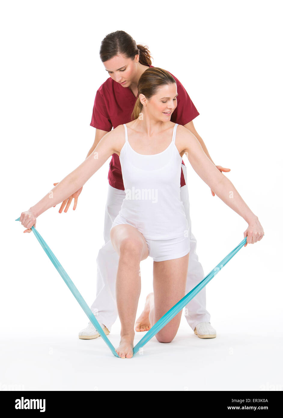 woman with physiotherapist reinforcing arms with rubber bands Stock Photo